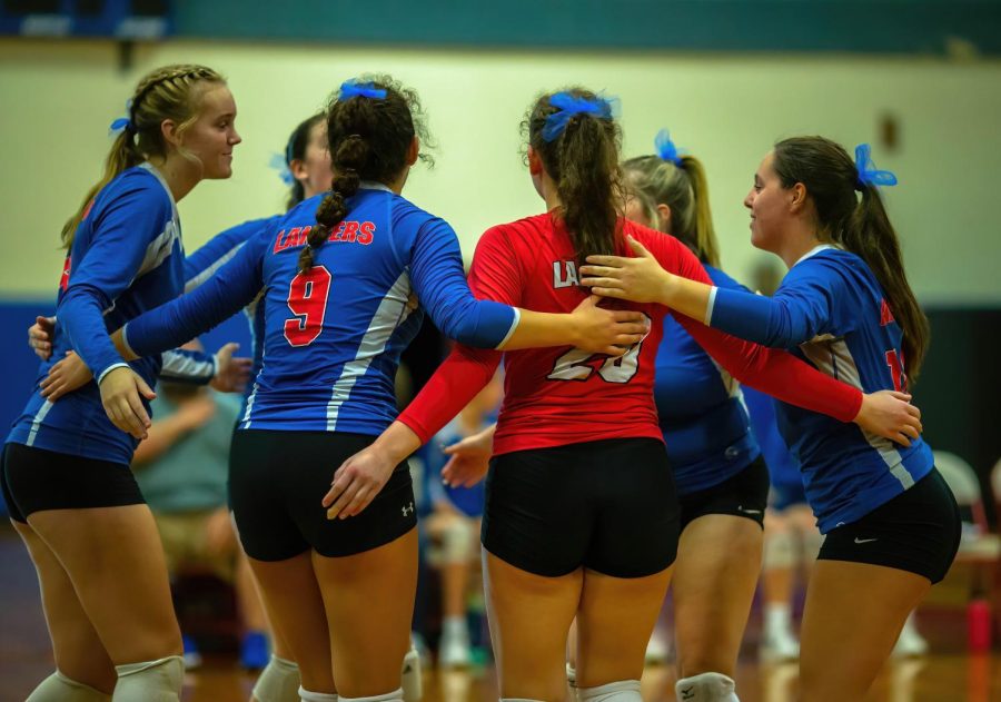 Teammates come together to celebrate after scoring.