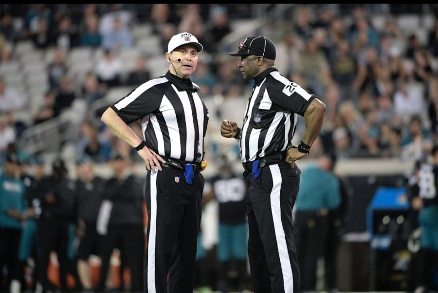 Two refs discussing the play. 