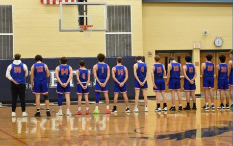 The team stands for the national anthem before their 72-64 win against Portsmouth. 