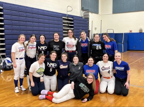 The 2023 Varsity Softball team poses after the varsity posting announcement this past March.