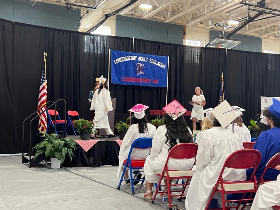 The graduates in the Adult Education Program walk across the stage to receive their diplomas.