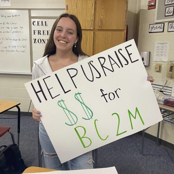 Senior, Bring Change to Mind membership coordinator, and volleyball team captain Abby Harrington promotes the Bring Change 2 Mind green out volleyball game. The club hopes to raise money for a guest speaker on the annual Lancer Speak Up Day. (Photo used with permission by Abby Harrington)