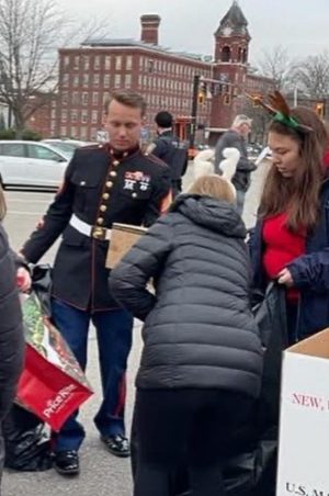 A U.S. Marine greeted the Community Service Club when they brought toys for the WMURs Toys for Tots Drop-Off Day.