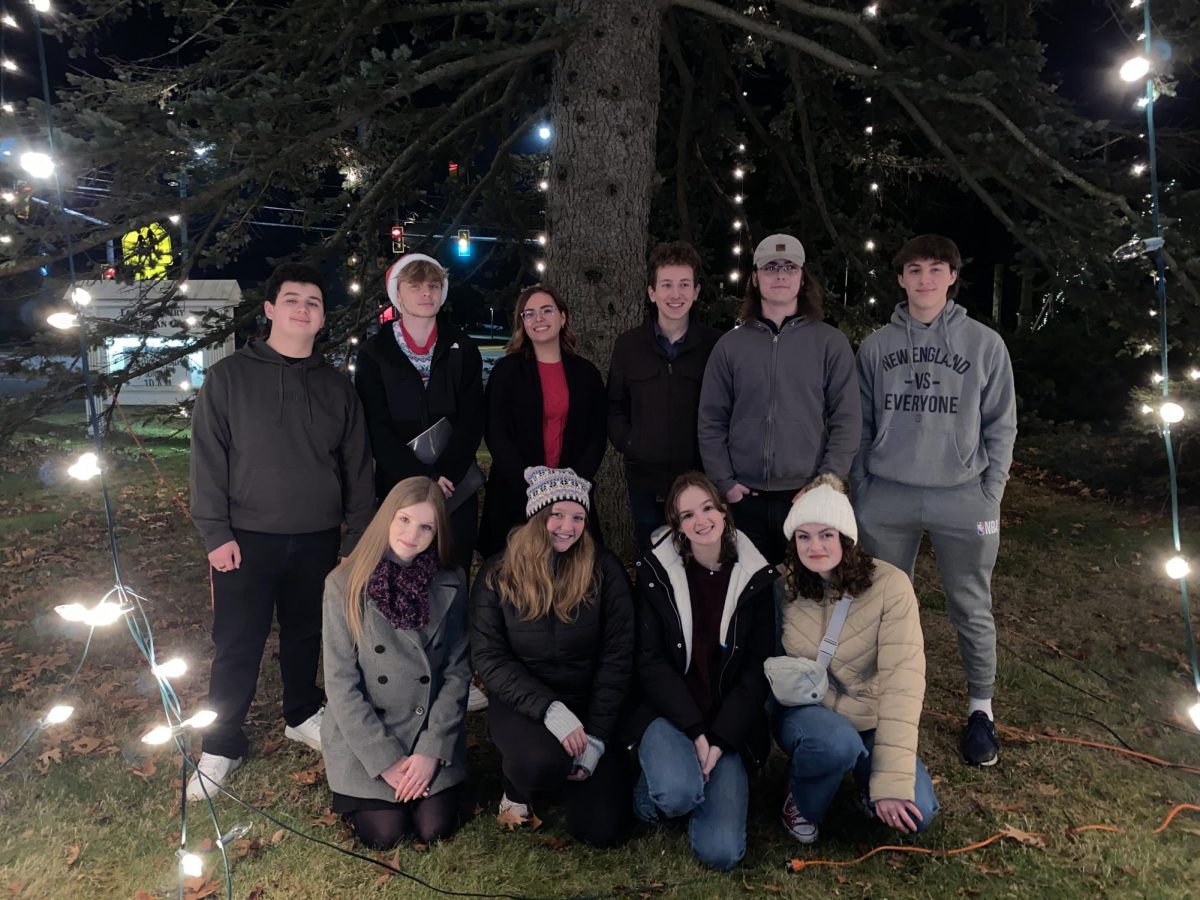 Nove Voci stands in front of the tree after a successful performance 