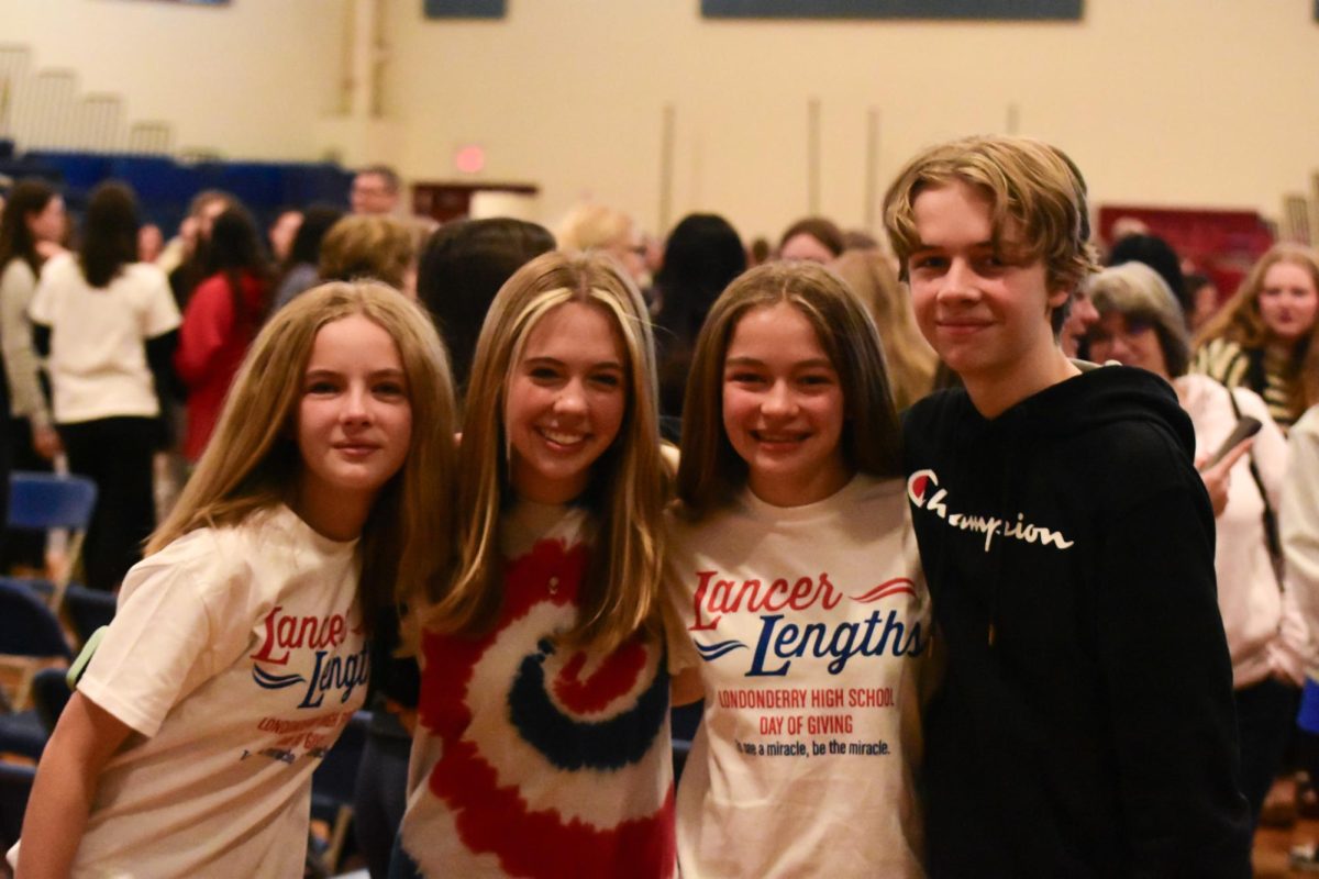 Siblings pose for an after-cut picture to show their donation.