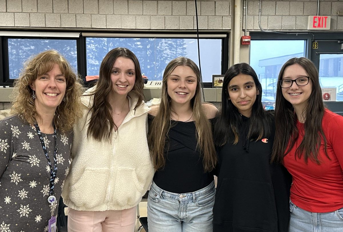 (From left to right) Adviser Jennifer Anderson, president Ava Griffin, vice president Brenna Langley, secretary Mishal Khan, and publicist Ava Blackington during a meeting of the Fashion club in room 302. According to Langley, the group aims to “create a community through fashion” by exploring ways to express themselves through style (Photo by Bridget Berry).