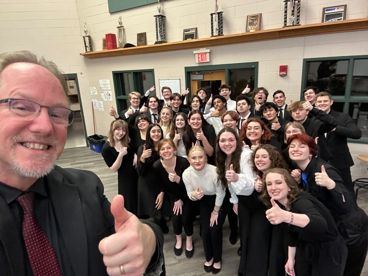 Conductor+Dr.+Kevin+McDonald+with+the+Honors+Choir.+Dolan%2C+a+member+of+the+ensemble%2C+says+the+group%E2%80%99s+mutual+love+of+music+bonds+them.+%E2%80%9CIn+school+ensembles%2C+theres+often+a+few+people+who+dont+love+music+as+much+as+you+do%2C+but+in+this+group%2C+youre+surrounded+by+people+with+a+similar+passion.+And+because+of+that%2C+the+group+seemed+to+click+much+faster+than+in+school+ensembles.%E2%80%9D+%28Photo+used+with+permission+by+Timothy+Dolan.%29