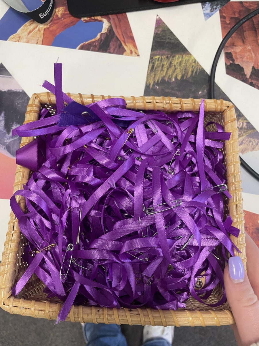 The Blue and Purple Star Lancers finish tying up the remainders of their purple ties   during their first meeting during Purple Up Month 