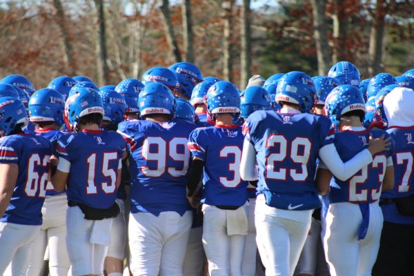 The team gathers in a pre-game huddle, ready to push their way into the next round of playoffs. 