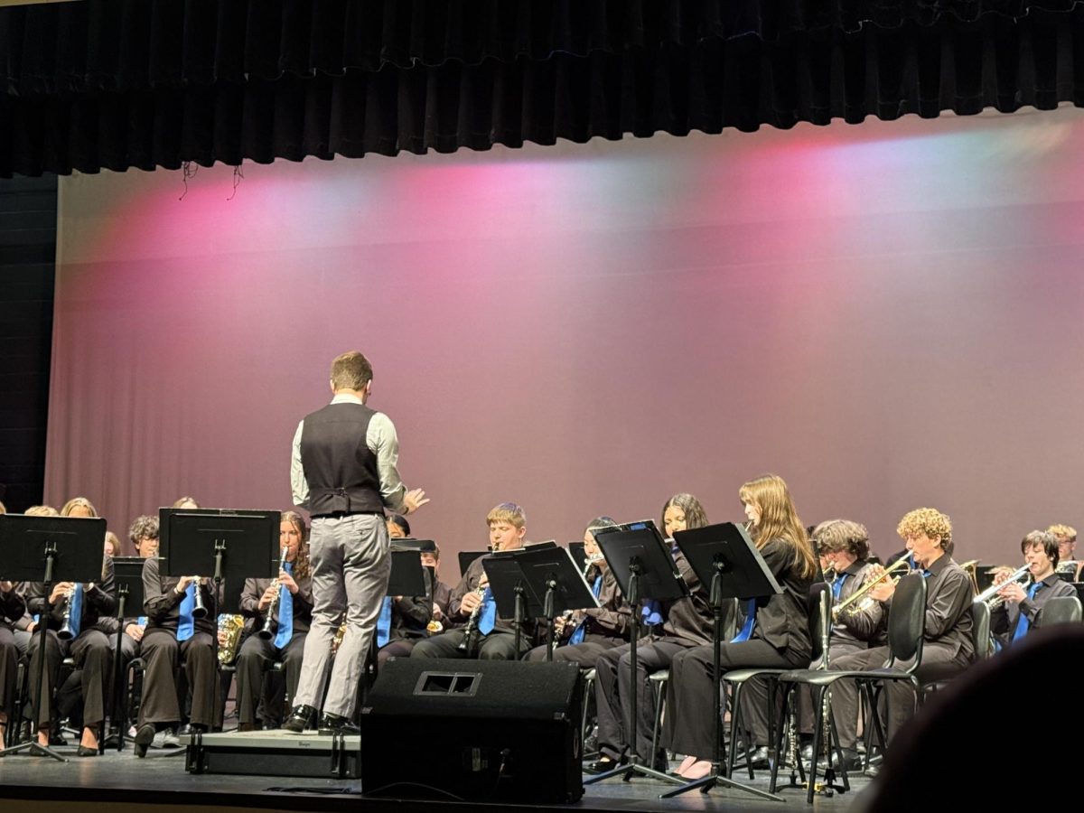 Mr. Devin DiBernardo conducts concert choir through their last concert of the year. 