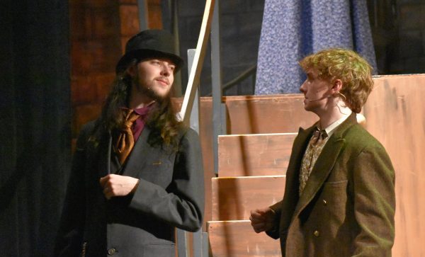 Senior Alex Barnes (Beadle) introduces their scene parter Cameron Fraser (Judge Turpin) during the masquerade scene. 