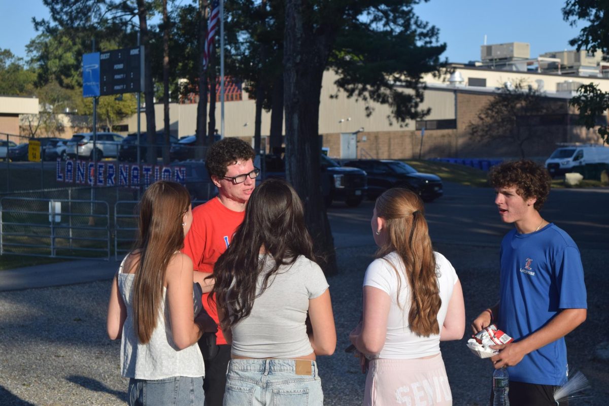 Groups of students catch up after school hours while talking about future events.