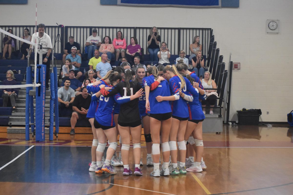 Team prepares and discusses pre-game strategy before their 3-0 victory over Nashua South.