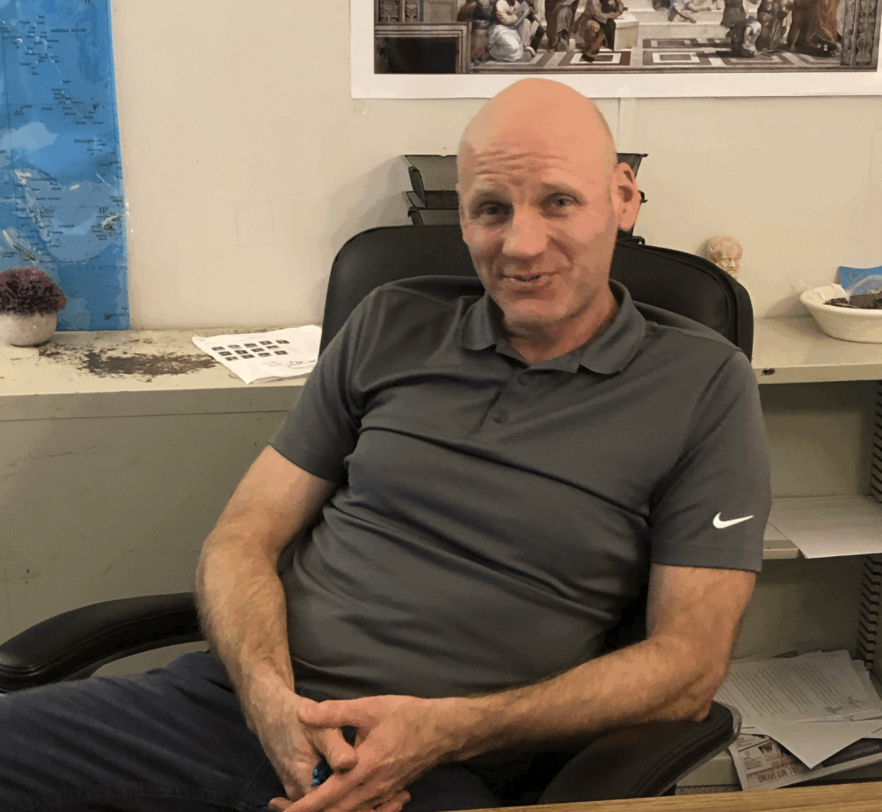 History teacher Mike Miller relaxes at his desk after a long day of teaching. When he was not teaching, Miller found pleasure in spending time alone, but looked forward to spending time with his family. “I’m a family guy,” Miller said. “I love times with my daughters, my wife, my Friday nights. They are real special to me because they offer something to look forward to after school.” Photo by Jansher Malik.