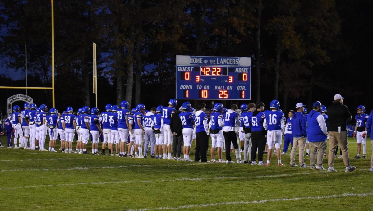 The players line up on the hashes as the seniors walk out for their final home game. 
