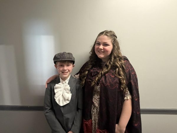  Junior Sarah Fitzpatrick, who plays Fan, with sixth grader Luke Anderson, who plays Young Ebeneezer Scrooge.  “I've played so many roles throughout my time in ‘A Christmas Carol,’” Fitzpatrick said. “I have had great experiences of getting to play the sisters of the show, Belinda Cratchit and Fan.”
Photo used with permission from Sarah Fitzpatrick.