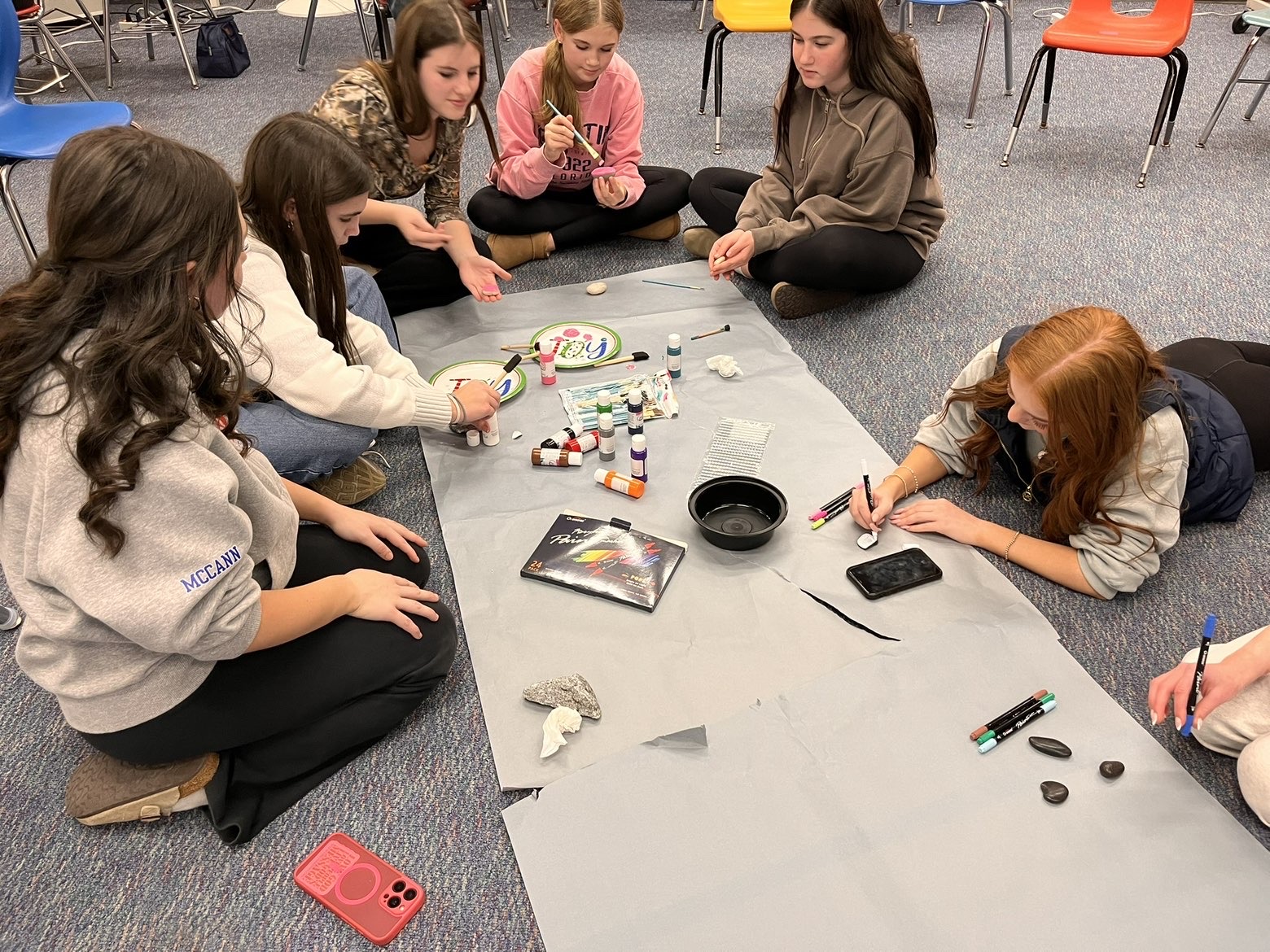 The Lighthouse Club paints positivity rocks as they prepare for the annual LHS craft fair. (Photo used with permission by Sky Pfaff).