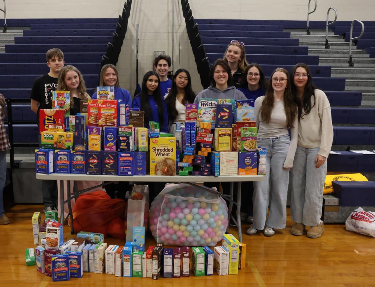 Student Council members and volunteers display all of the collected donation in preparation for the assembly.