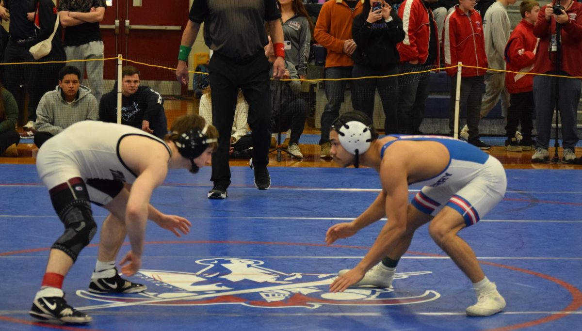 Sophomore Cam Roussell wrestles his last match before qualifying for finals in the 120 pound weight class. 