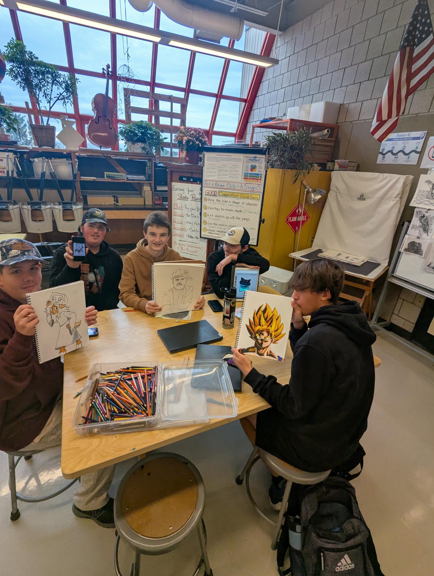 Left to right: Sophomores Zach Clifton, Nick Van Dyne, Owen Dutil, Kenneth Roberge, and junior Mason Hernandez holding up art they are working on at art club. “It’s fun to do some art and also just goof around with my friends,” Roberge said.