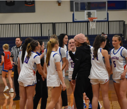 The Lancers celebrate and exchange high fives following a timeout during their game against Trinity on Feb. 13. “We’ve built such a strong connection as a team, and everyone genuinely wants the best for one another,” Sullivan said.