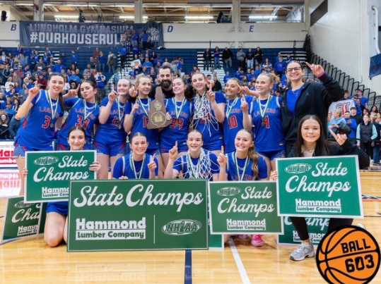 The girls basketball team gets together after receiving their medals and championship plaque. (Photo used with permission from Sammie Sullivan)