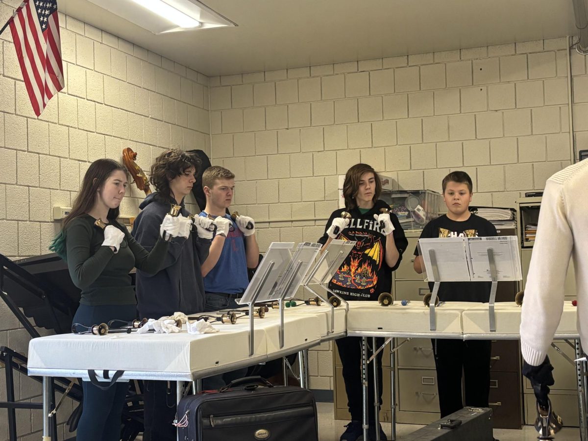 Members of the handbell choir work diligently at an after school practice while they play Opus 4. The handbell choir’s treble line consists of bells from middle C and above. 