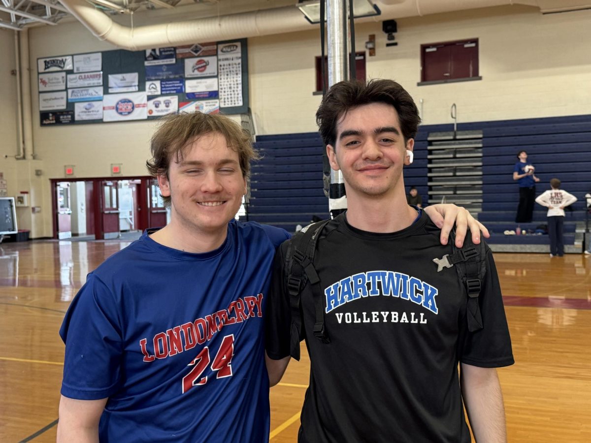 Seniors Dylan Dugen and Peter Pispitsos share a moment before their game against Hollis-Brookline on April 24. (Photo by Mary DeWinkeleer)
