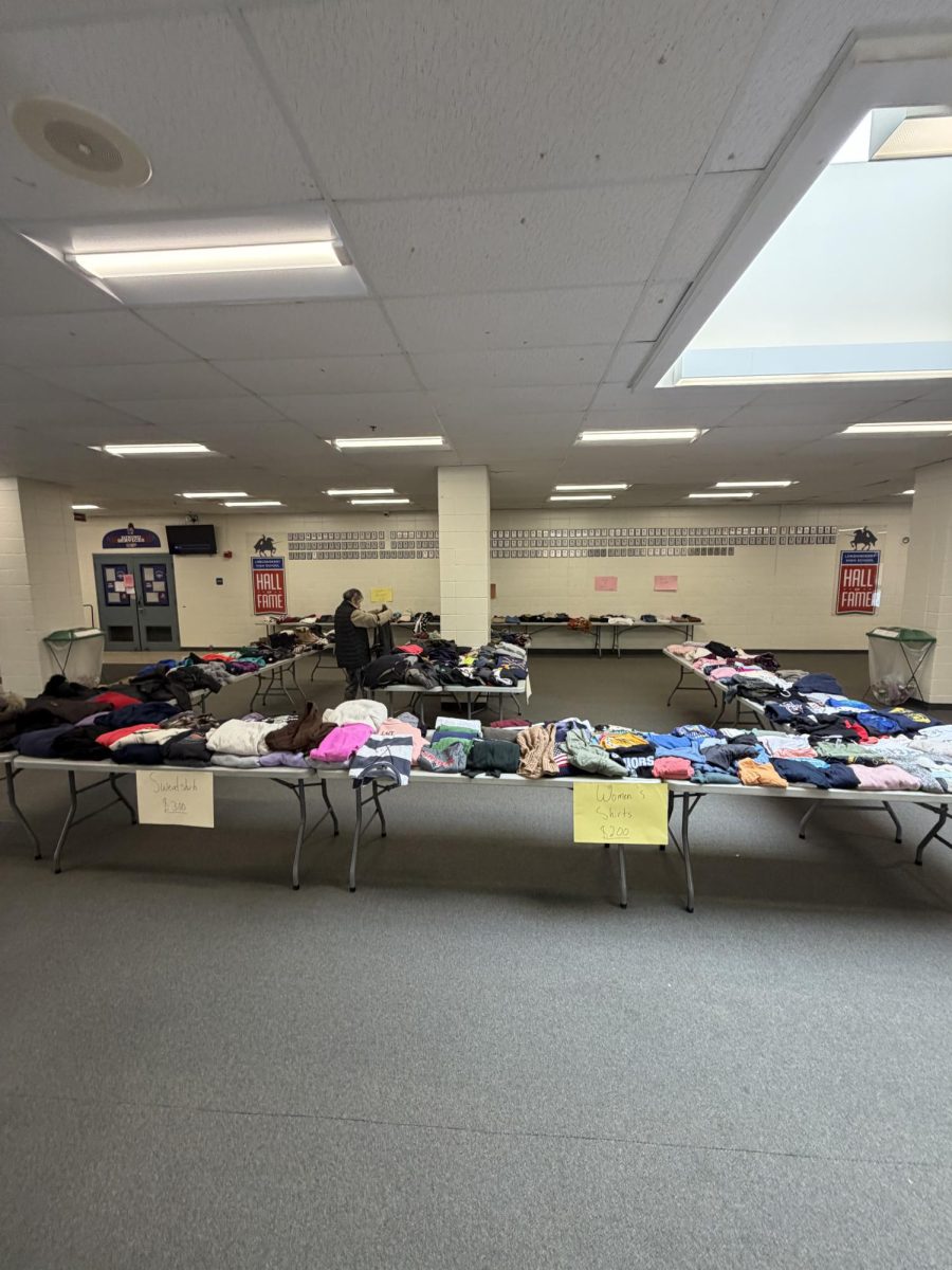Clothing items are displayed for sale during the annual Green Council thrift affair, where community members gather to shop for affordable, gently used apparel and promote sustainable practices, in the LHS lobby on Dec. 13. (Image used with permission by Benjamin Bristol.)