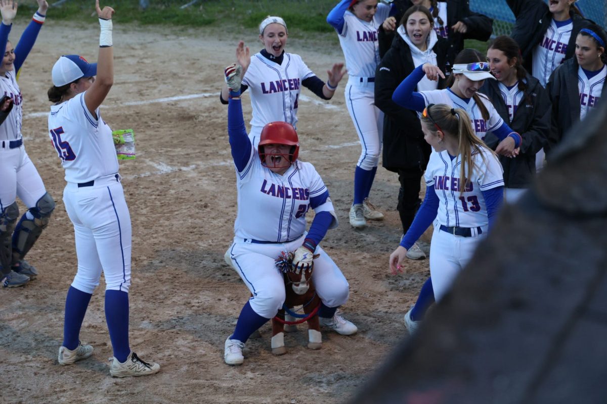 Senior Virginia Flaherty celebrates after recording her 100th career hit, marking a major milestone in her high school softball career and helping lead the Lancers on the field this season. (Image used with permission by Virginia Flaherty) 