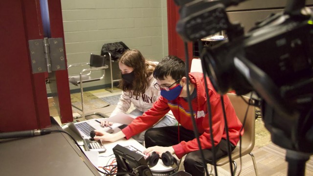 Junior Ahna Gainey and senior Garrett Calusdian prepare the livestream for the pep rally to play in real time for students and staff. Photo by Sean O'Mara
