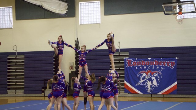 The varsity cheer team showing off their talent in a pyramid during their routine. Photo by Sean O'Mara