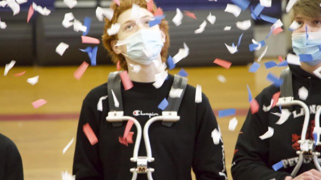 Senior Dylan Solano looks up as confetti rains down, celebrating the Winter Percussion Team’s success in the previous year. Photo by Sean O'Mara