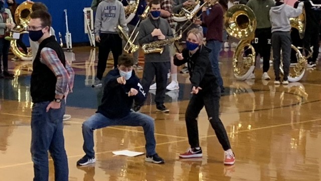 Drum Majors, senior Tyler Kraics and Amanda Curry, have some fun posing for the camera, while preparing to conduct the Marching Band. Photo by Spencer McIntyre