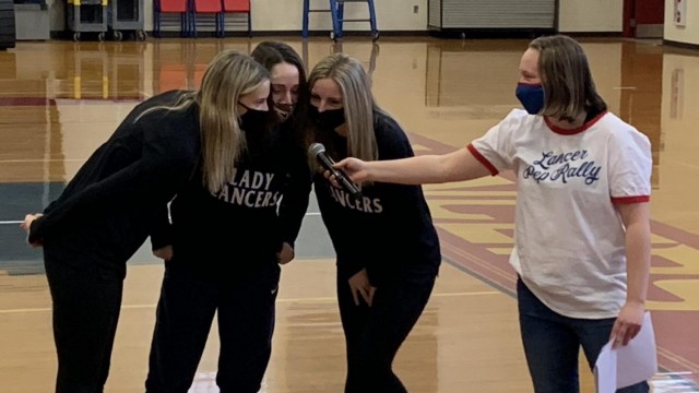 Three representatives of the Lady Lancers announce the closing act of the Winter Pep Rally. Photo by Spencer McIntyre