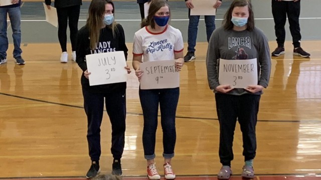 Three winter sports team representatives participate in the traditional game, this year involving signs that indicate the players’ birthdays. Photo by Spencer McIntyre