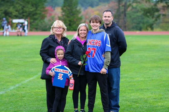 Helper Mike Williams and his family celebrate Senior Night.
