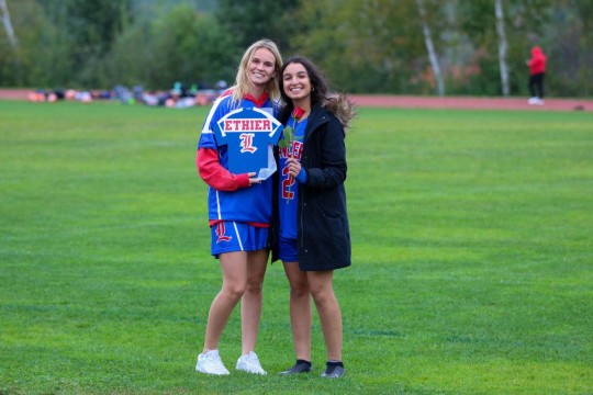 Helper Sara Ethier and teammate Shayana El Ghazal celebrate Senior Night.