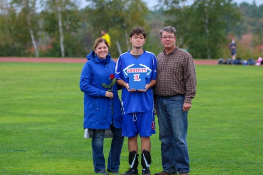 Athlete Ben Laverty and his parents celebrate Senior Night.