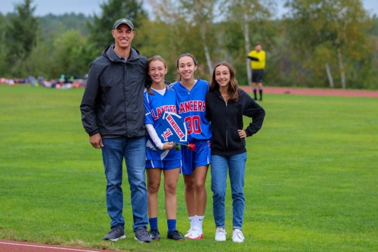 Helper Olivia Windisch and her family celebrate Senior Night.