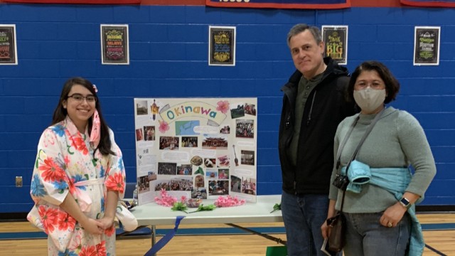 President of International Club, Cassidy Methot educates John Savina and Nora Colliton about Okinawan culture.