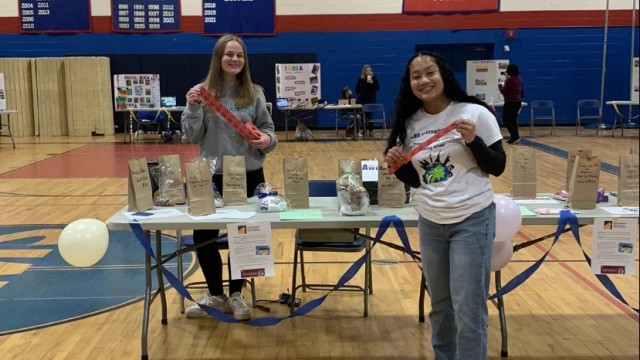 Juniors Kathryn Martin and International Club Secretary, Olivia Colliton-Savina, help sell raffle tickets at the festival.