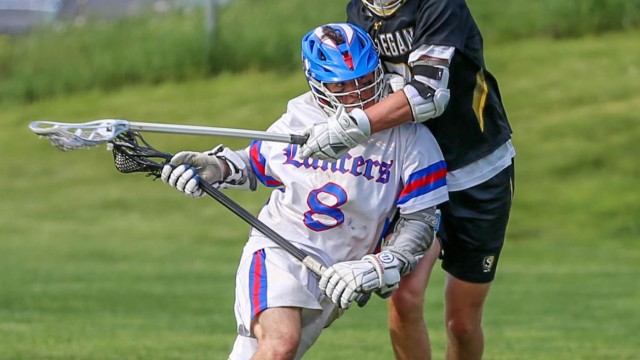 Senior Josh Defranzo speeds past Souhegan player to the net.